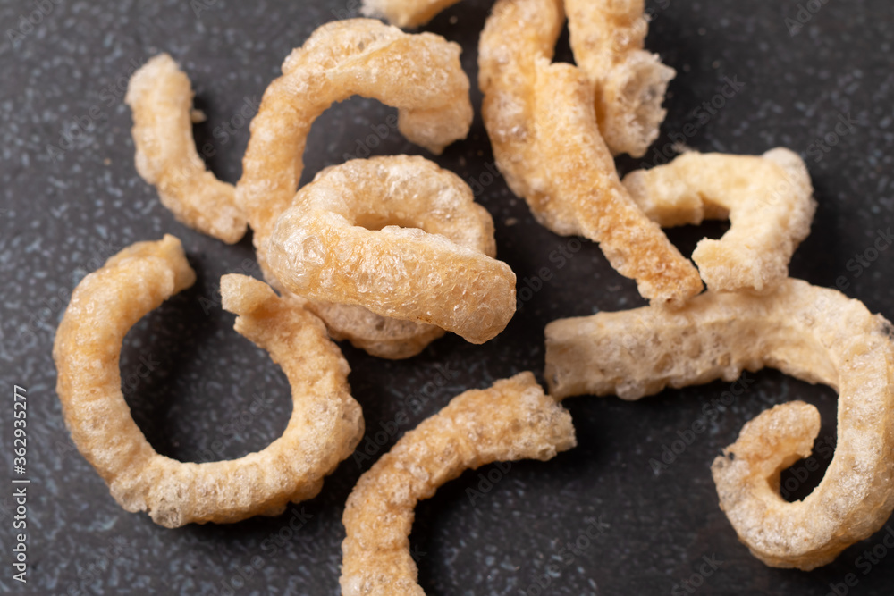 pork rind in a cup on a black background. Thai food pork rind in a cup on a black background. Thai food
