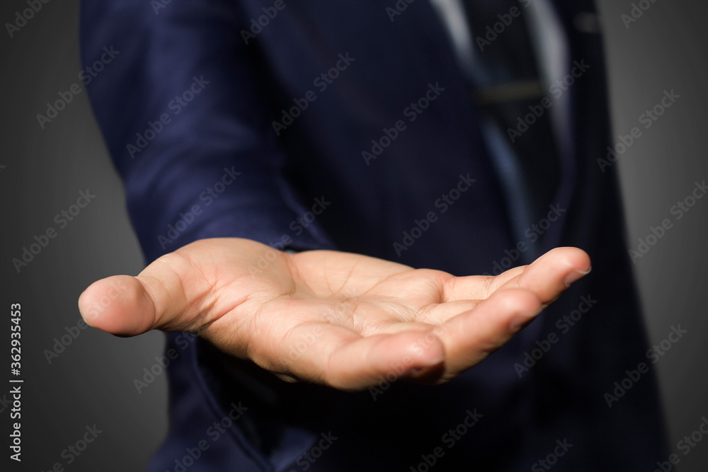 Fototapeta premium A businessman empty hand with black background