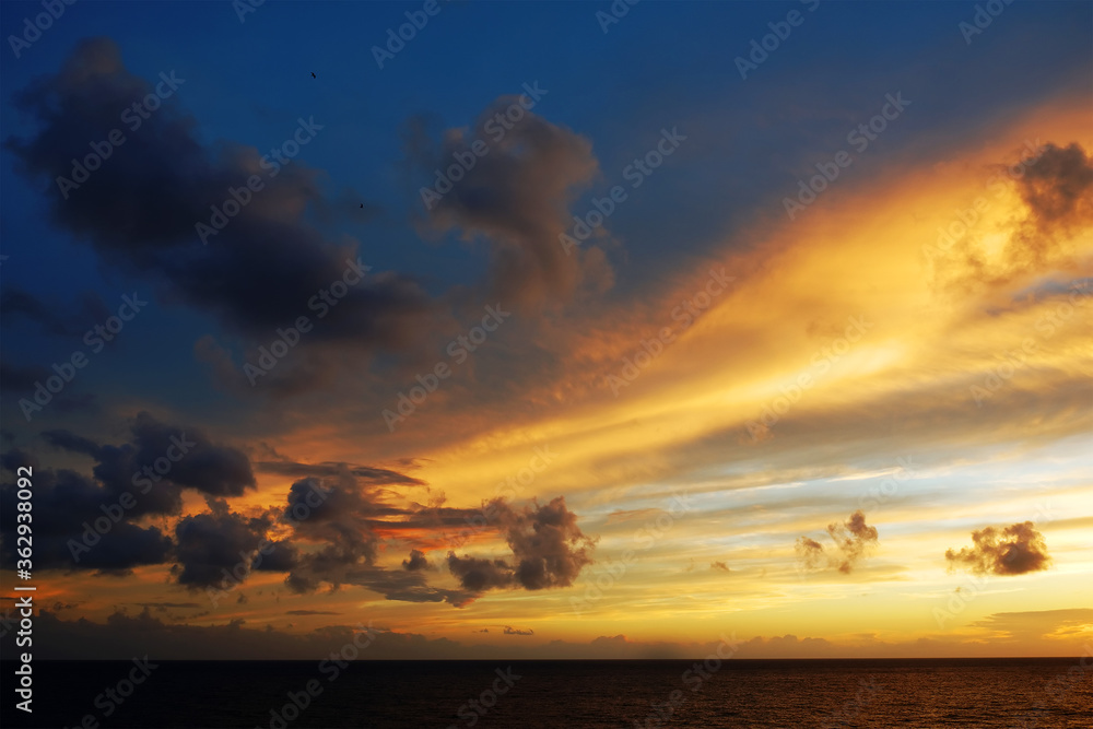 Dramatic sunset cloudy sky with picturesque clouds lit by warm sunset sunlight, natural sunset sky landscape view,natural sunset sky background, colorful sunset sky with dramatic sky clouds lit by eve