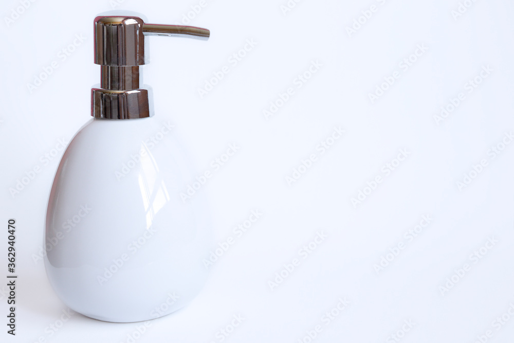White soap dispenser against white background White soap dispenser against white background