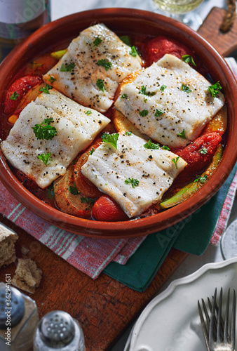 Fotografie Galician spanish hake baked on tomatoes and peppers with white wine