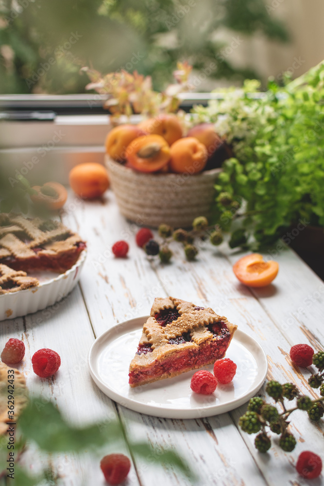 Homemade cooking bakery, summer berry pie with raspberry and apricots, rustic wooden table Homemade cooking bakery, summer berry pie with raspberry and apricots, rustic wooden table