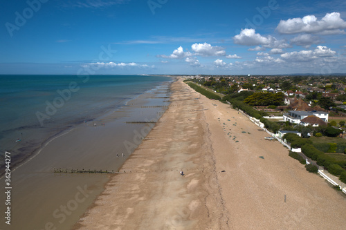 East Preston beach aerial photo looking west on a warm and sunny English summers day .