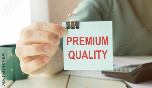 Business woman showing a post-Premium Quality, concept premium