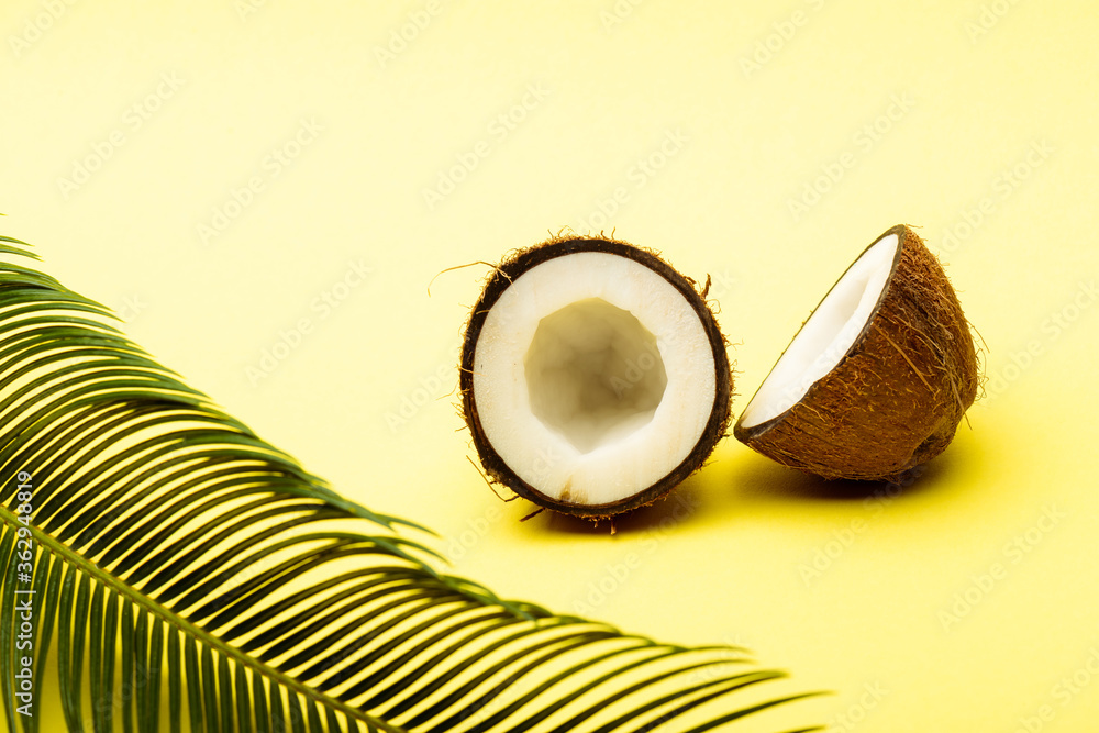 delicious sweet coconut and palm leaf on yellow background