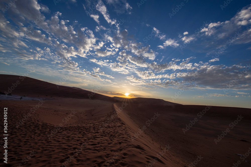 Sossusvlei is a salt and clay pan surrounded by high red dunes, located in the southern part of the Namib Desert, in the Namib-Naukluft National Park of Namibia.