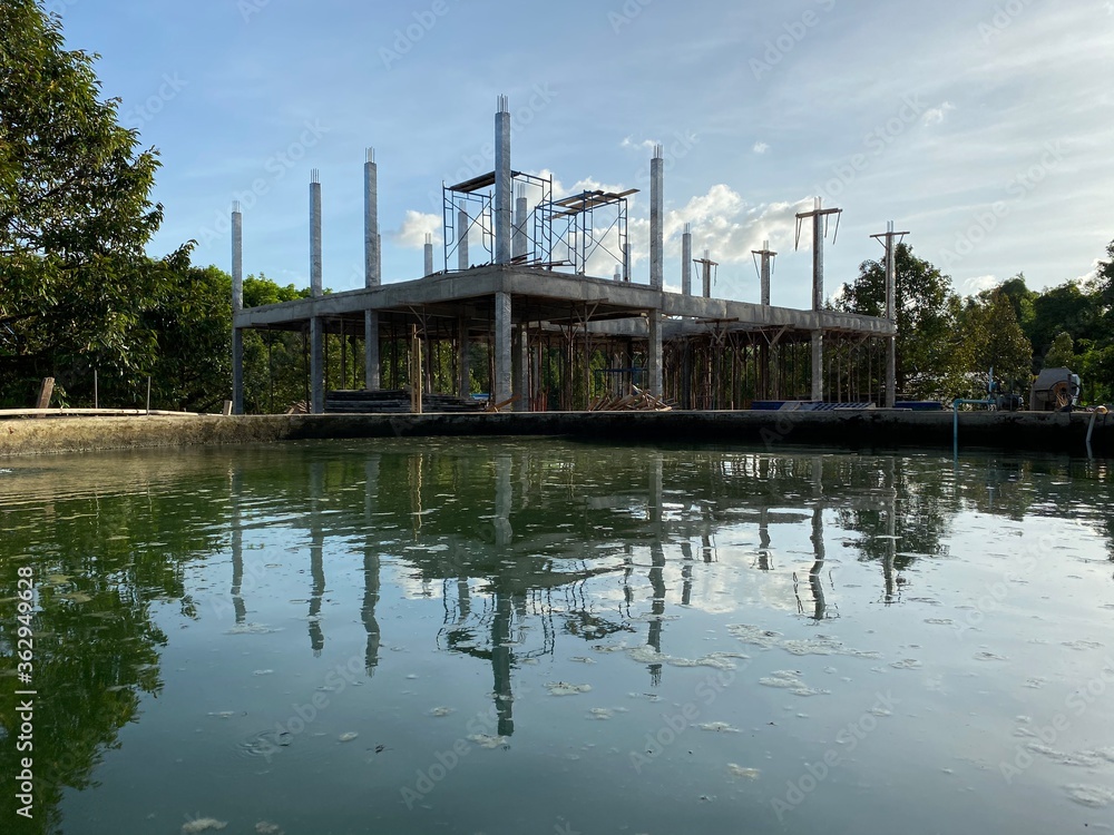 Naklejka premium construct a house in the garden with pond