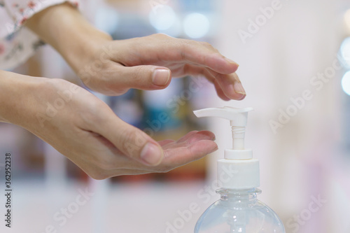 Woman hand press sanitizer bottle to clean her hand. hygiene prevention of coronavirus  Covid-19  virus outbreak.