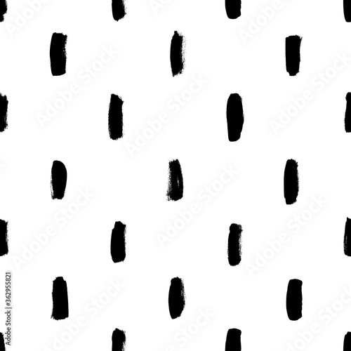 Vertical brush strokes vector seamless pattern. Black paint scribbles, dash lines, dry brushstroke texture. Regular rough smears. Black and white monochrome texture. Hand drawn grunge ink shapes.