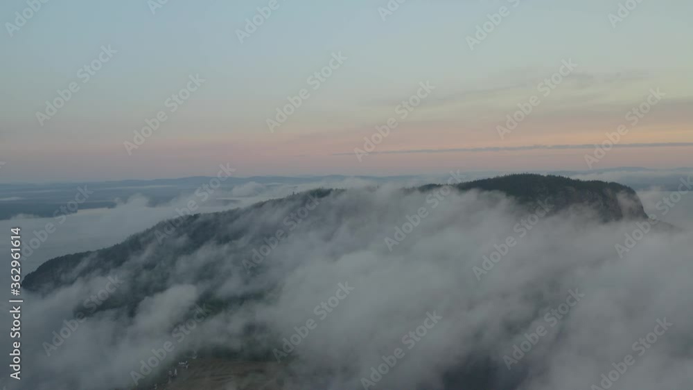 Sunrise overlooking Mount Kineo capped with thick fog, Aerial shot Sunrise overlooking Mount Kineo capped with thick fog, Aerial shot