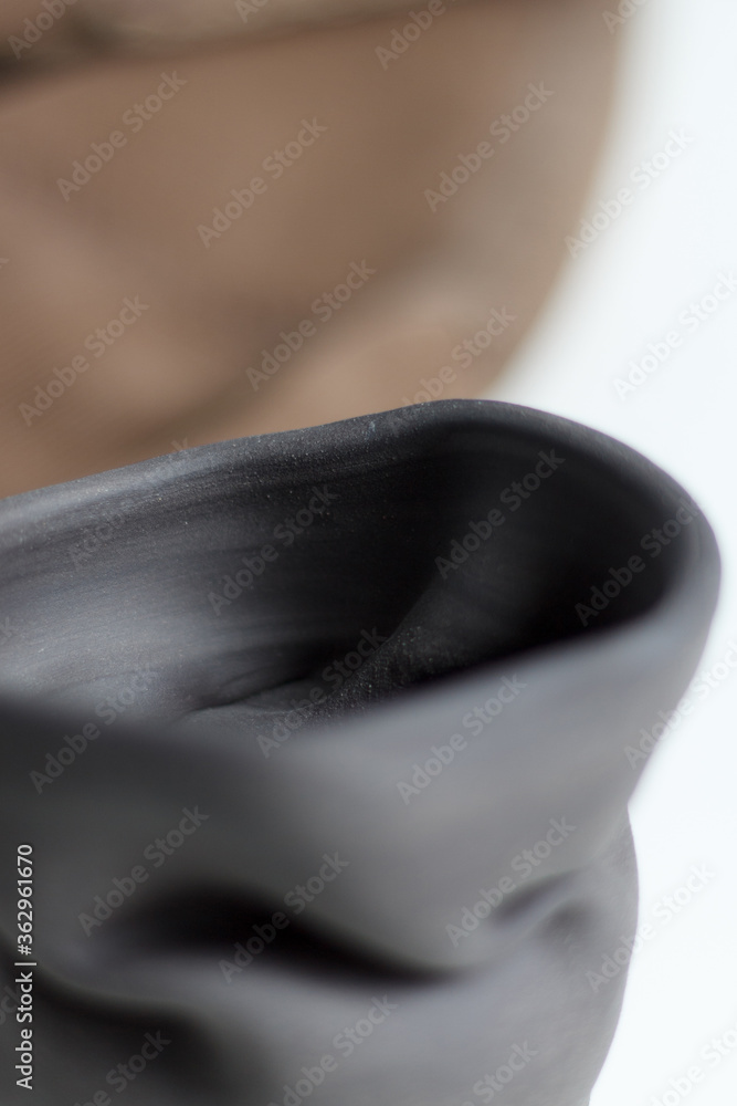 ceramics designer glass made of black gray clay. Ceramist concept. gray clay closeup with blurry background. ceramics designer glass made of black gray clay. Ceramist concept. gray clay closeup with blurry background.