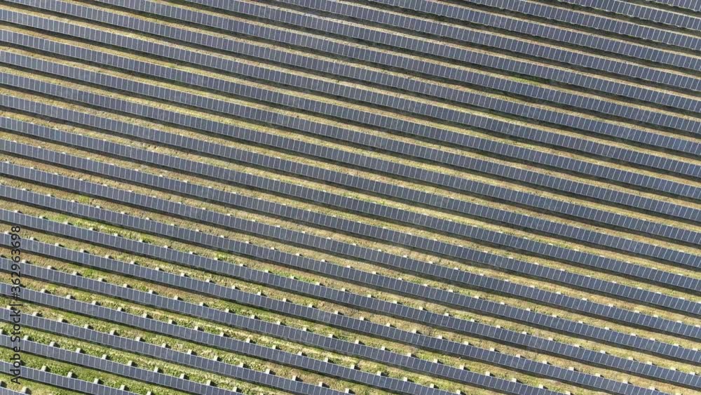 Aerial 4K drone shot of solar panel farm, camera tilting up while descending Aerial 4K drone shot of solar panel farm, camera tilting up while descending