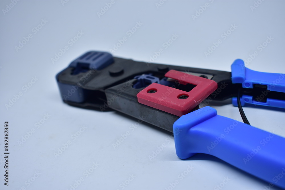 reliable tool for crimping connectors and twisted pair RJ-45 on white background
