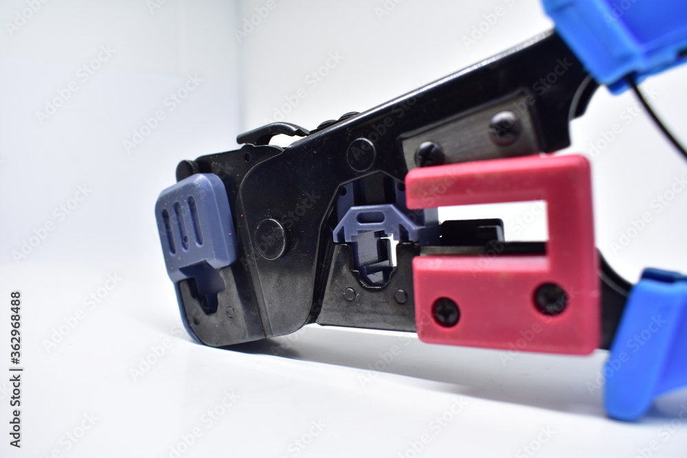 reliable tool for crimping connectors and twisted pair RJ-45 on white background
