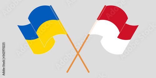 Crossed and waving flags of the Ukraine and Indonesia