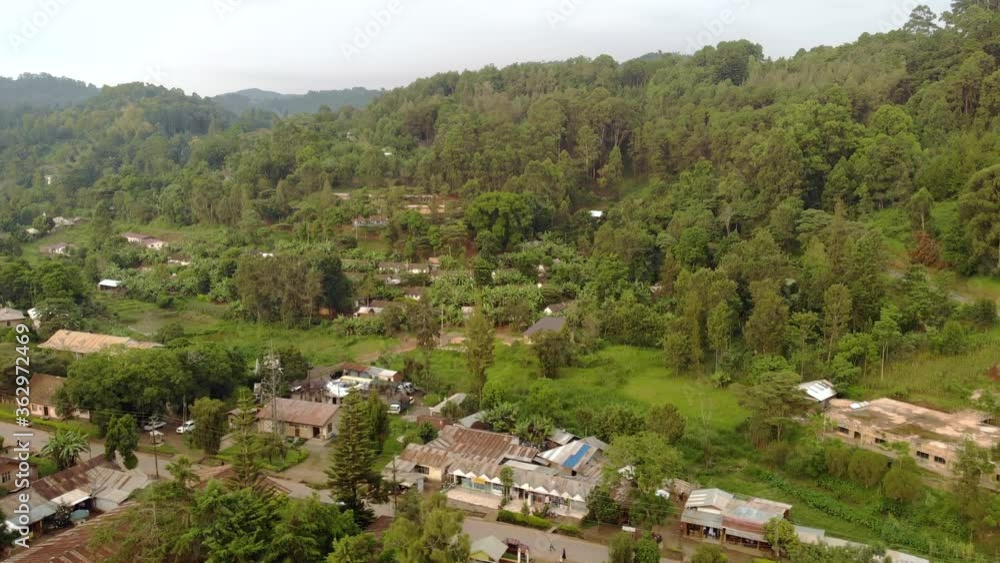 Aerial Flyby Shot of Lushoto Town based in Lush Mountain Tropical Forest in Tanga Region of Tanzania, Remote calm district in Usambara Mountains in East Africa Aerial Flyby Shot of Lushoto Town based in Lush Mountain Tropical Forest in Tanga Region of Tanzania, Remote calm district in Usambara Mountains in East Africa