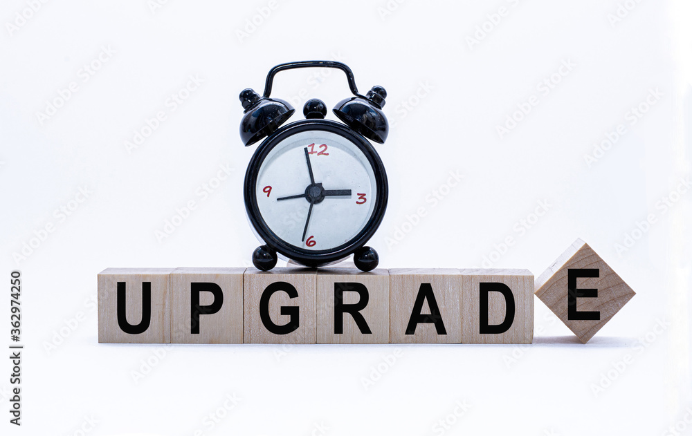 Business concept: Upgrade Word on Wooden Blocks and alarm-clock. Time is money. Time-limit. Business concept: Upgrade Word on Wooden Blocks and alarm-clock. Time is money. Time-limit.