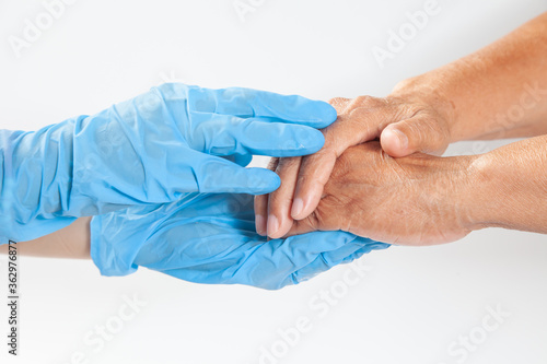 Old and young holding hands on white background . Close-up of tender Young woman holding hands with a senior lady hands show encourage