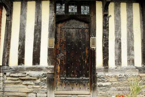 Wall and building with wooden door in the middle, typical Tudor English style in Stratford  Upon Avon, England, UK