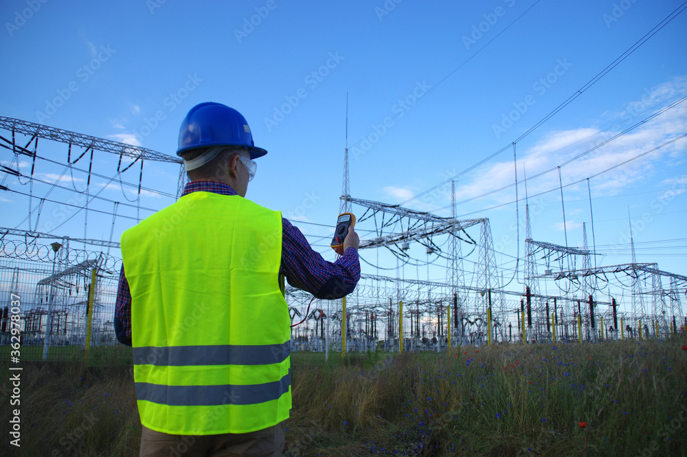 Engineer with a meter. Electric power production and energy industry. Engineer with a meter. Electric power production and energy industry.