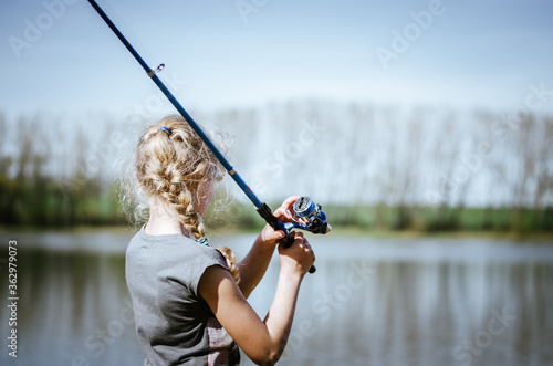 Fototapeta cute girl holding a fishing rod