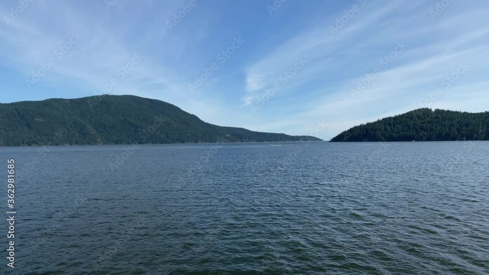 Ocean view with mountains, blue sky and white clouds at summer day in slow motion. Ocean view with mountains, blue sky and white clouds at summer day in slow motion.