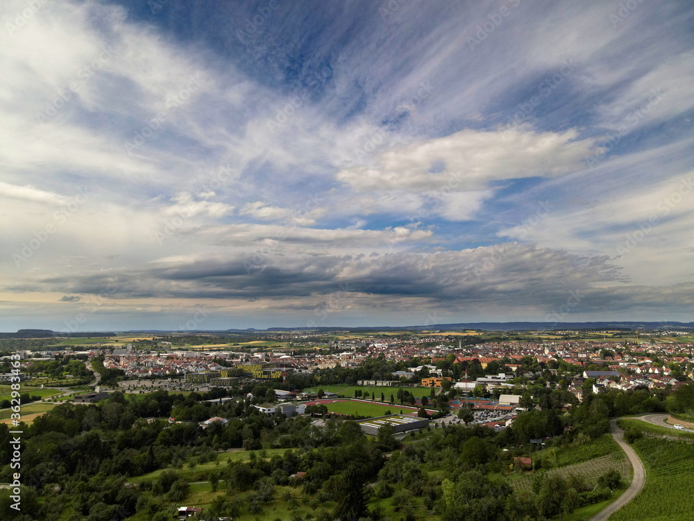 Beautiful view from above of the city in southern Germany against a background of blue sky and white clouds