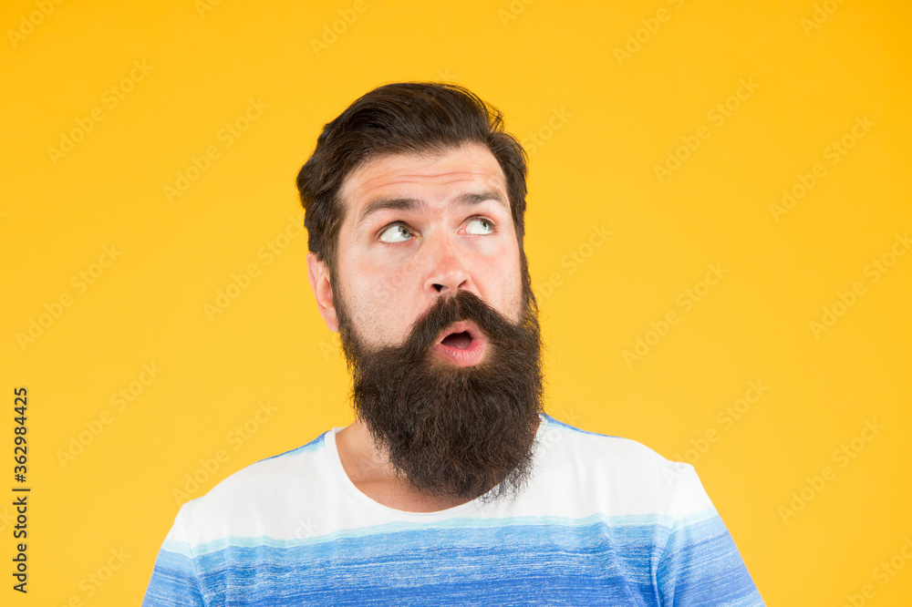 search for inspiration. surprised looking guy. male barber care. get style in barbershop. brutal bearded man on yellow background. male summer fashion. mature hipster has perfect moustache