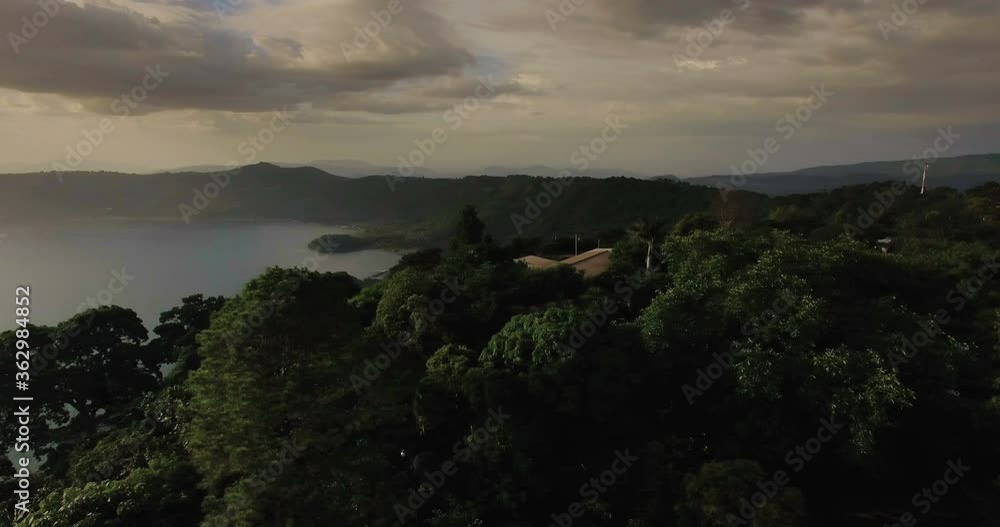 An aerial view of the lake Coatepeque in El Salvador during a golden sunset An aerial view of the lake Coatepeque in El Salvador during a golden sunset
