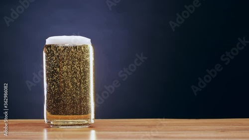 Beer sitting on bar with carbonated bubbles