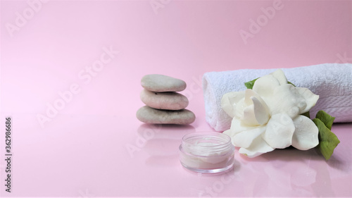 Spa setting and Spa background composition with white gardenia flower on pink background. Banner