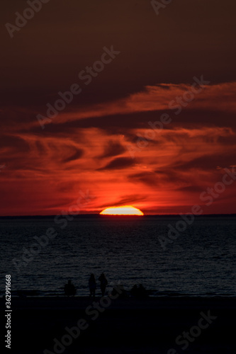 Photography Deep glowing red summer sunset at Mayflower Beach, Cape Cod.