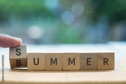 Fotografie SUMMER BUMMER concept on wood blocks as finger changes S to B