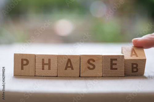 PHASE A B reopen project plan concept on wood blocks as finger changes phase