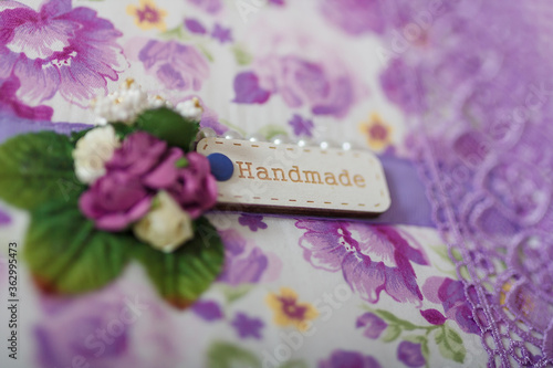 Fabric covered weddig scrapbook album with purple lace, flowers and inscription Handmade. Soft focused close up shot. photo