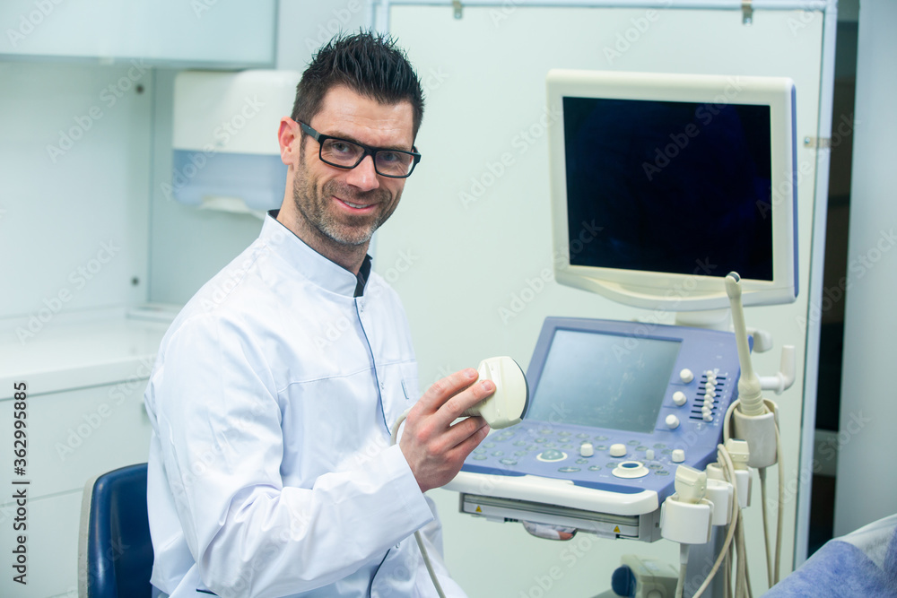Skillful sonographer using ultrasound machine at work Skillful sonographer using ultrasound machine at work