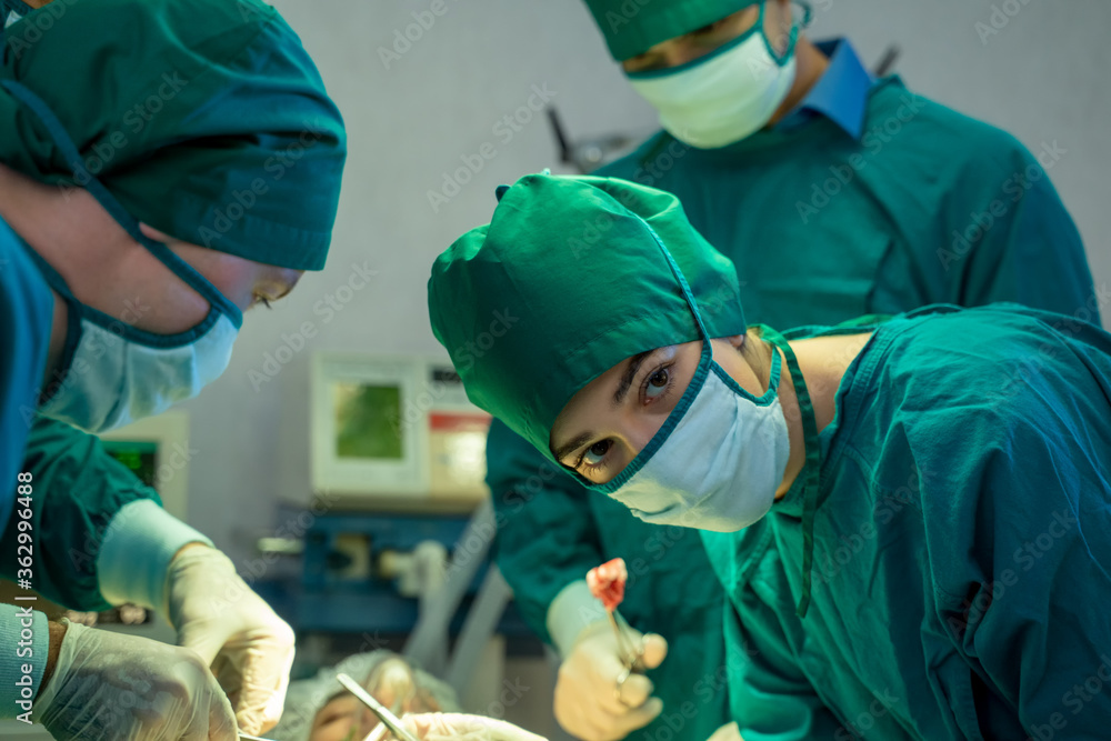 Doctors with surgery team operating in a surgical room at hospital. Doctors with surgery team operating in a surgical room at hospital.