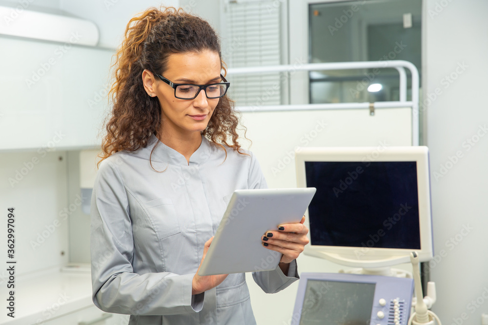 Skillful sonographer using ultrasound machine at work Skillful sonographer using ultrasound machine at work