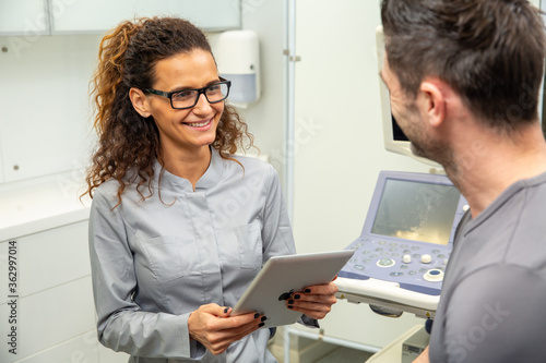 Skillful sonographer using ultrasound machine at work