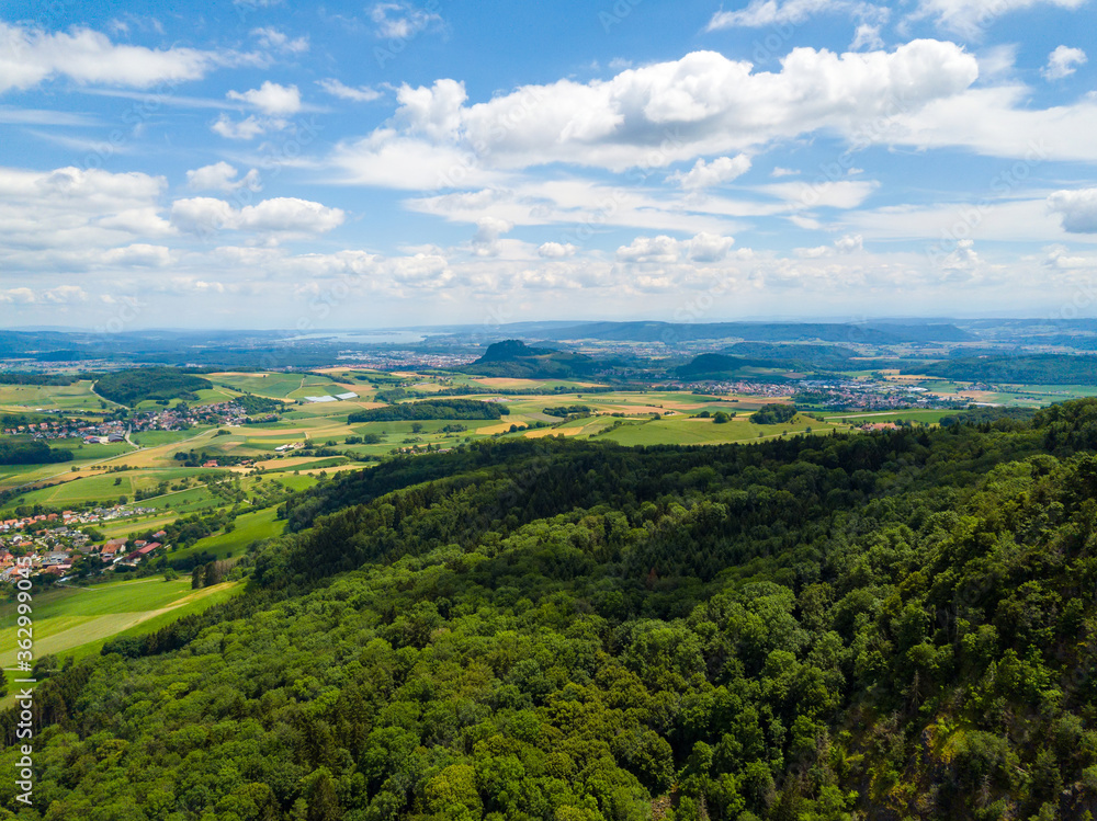 Fototapeta premium Aerial view over the long extinct volcanoes of the Hegau region towards Lake Constance in Germany.