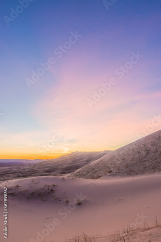 A dramatic sunset lights up the sand dunes of the Mojave Desert. Kelso Dunes, Mojave National Park, California, USA