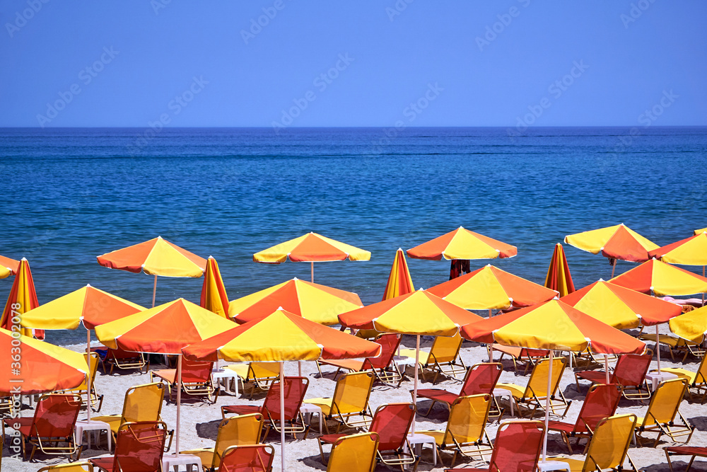 Umbrellas and beds on a sandy beach Umbrellas and beds on a sandy beach