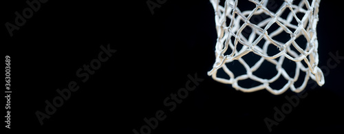 Empty Swooshing Basketball Net Close Up with Dark Background. Team sport conept..