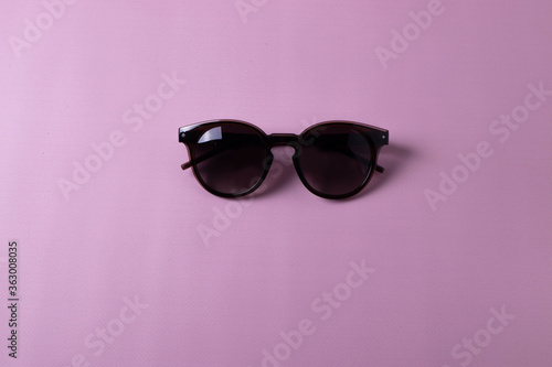 female trendy glasses on pink. minimalism style. flat lay