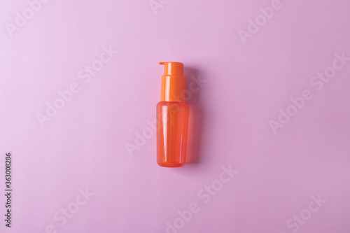 different cosmetic products for skin, body or hair care on pink background. flat lay, minimalism