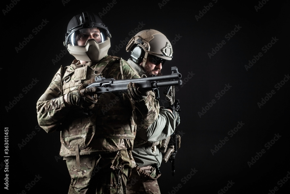 two soldiers in military uniform with weapons in a special operation at night, special forces attack against a dark background, elite troops two soldiers in military uniform with weapons in a special operation at night, special forces attack against a dark background, elite troops