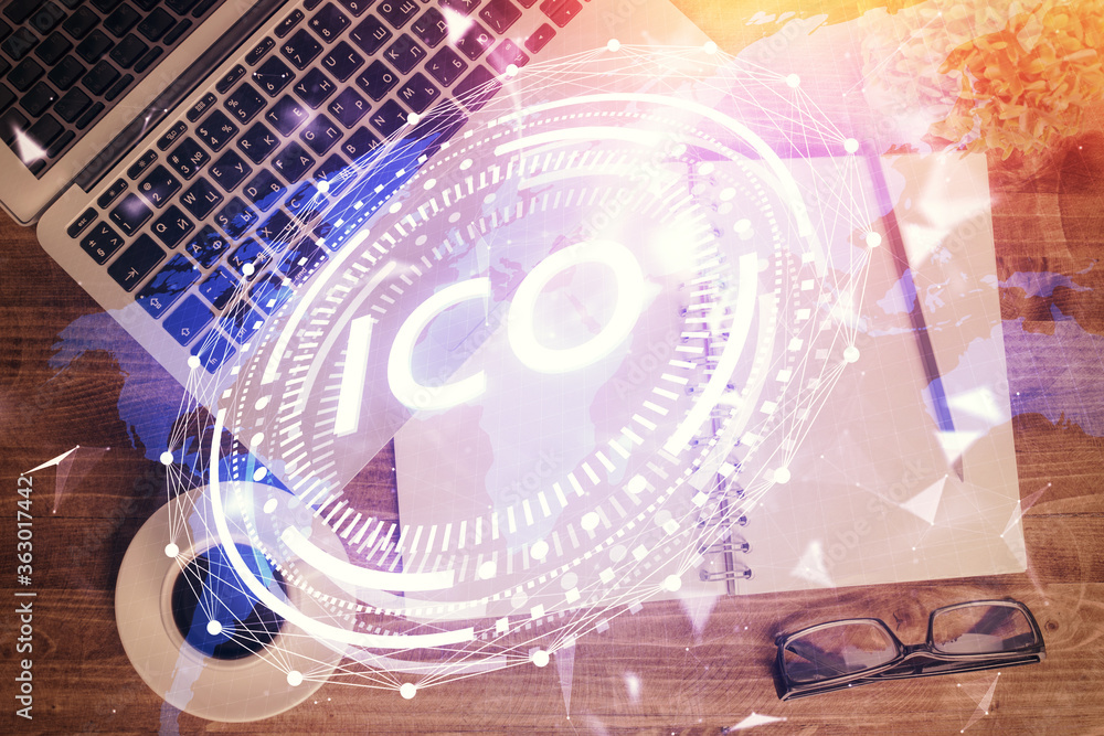 Blockchain theme hologram drawings over computer on the desktop background. Top view. Double exposure. Blockchain theme hologram drawings over computer on the desktop background. Top view. Double exposure.