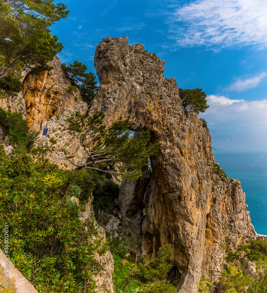 A view looking back to the elephant-shaped, natural arch from the coastal path on the island of Capri, Italy