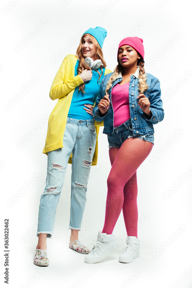 Fototapeta premium teenage girl friends cheerful having fun cute posing isolated on white background, lifestyle mixed races people concept, african and caucasian