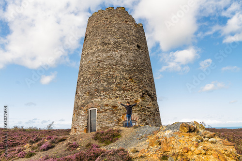 Ruined Windmill on Parys Mountain, Wales, small boy Arms outstretched   in front, photo